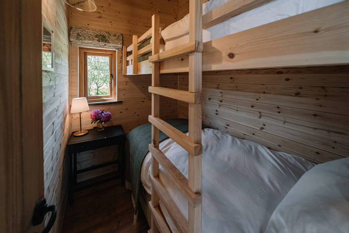 Bunk beds with cosy blankets and soft linens